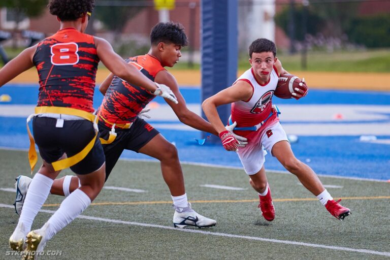 Boys flag football players running with the ball