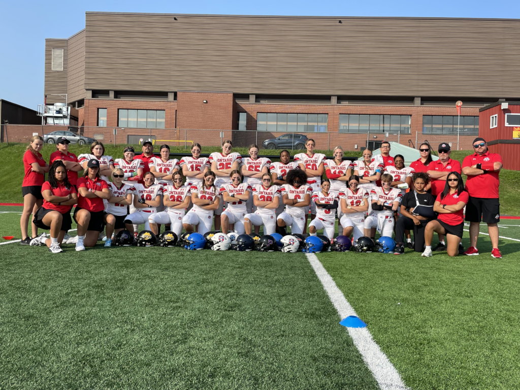 Ontario football team, coaches and staff gathered on the field