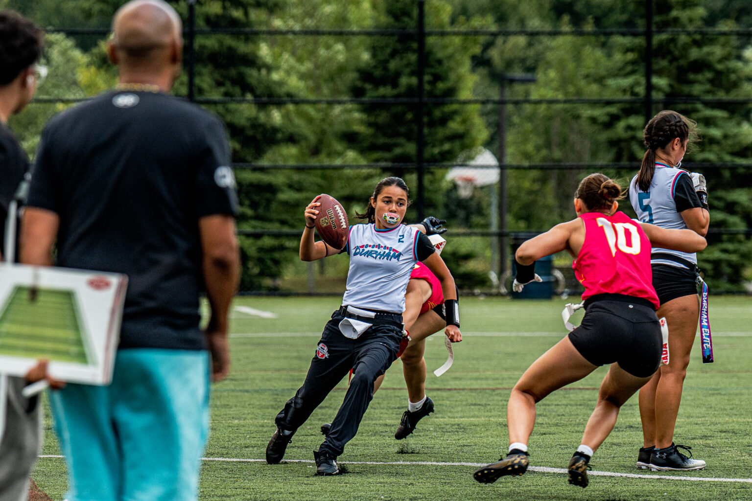 A coach working with a young flag football player