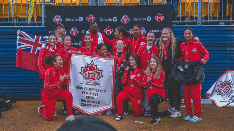 Players in Team Ontario apparel with a championship banner