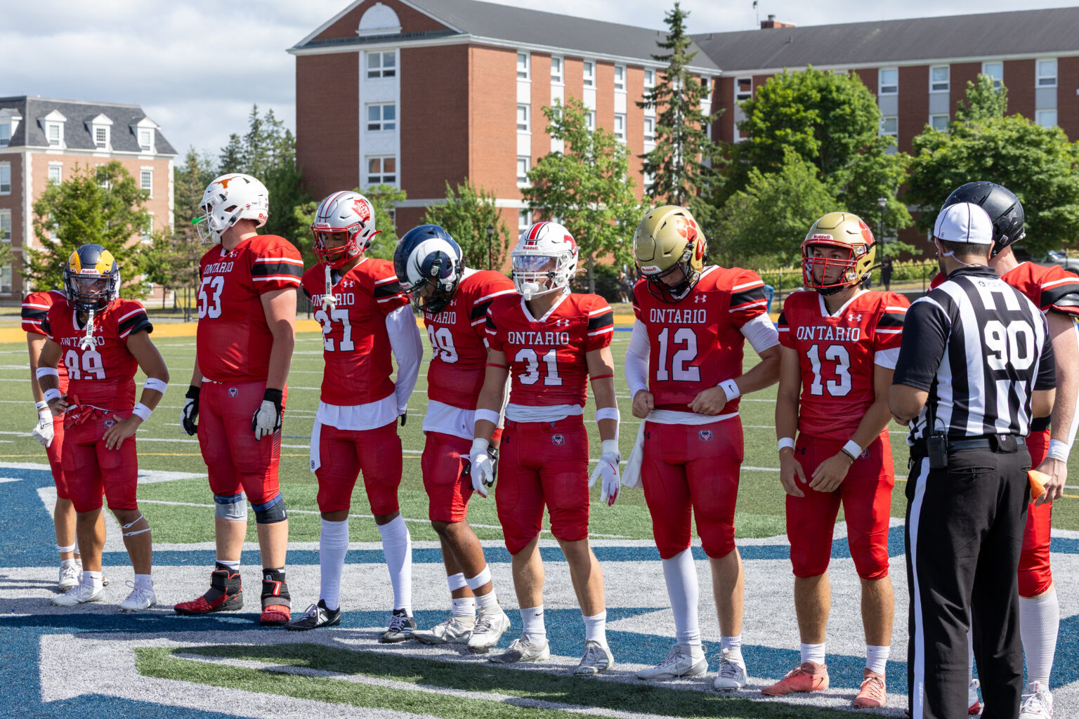 Ontario tackle players lined up on the field