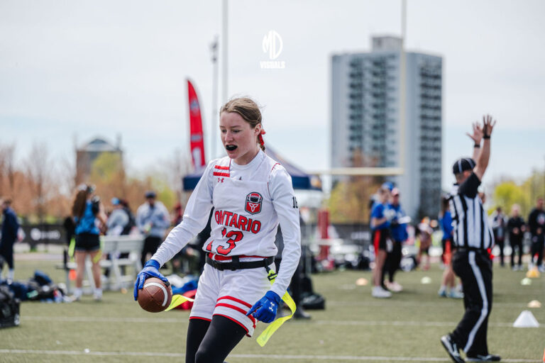 Flag football game in progress with an official on the field
