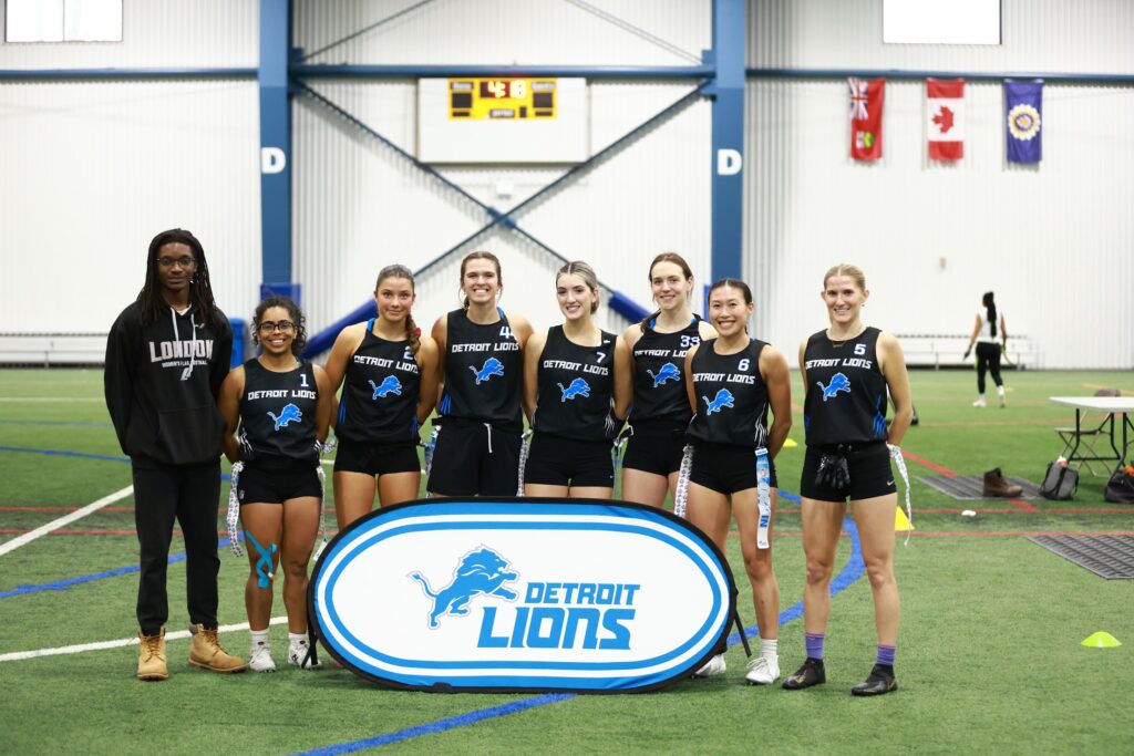 Ontario club flag team posing with their team banner