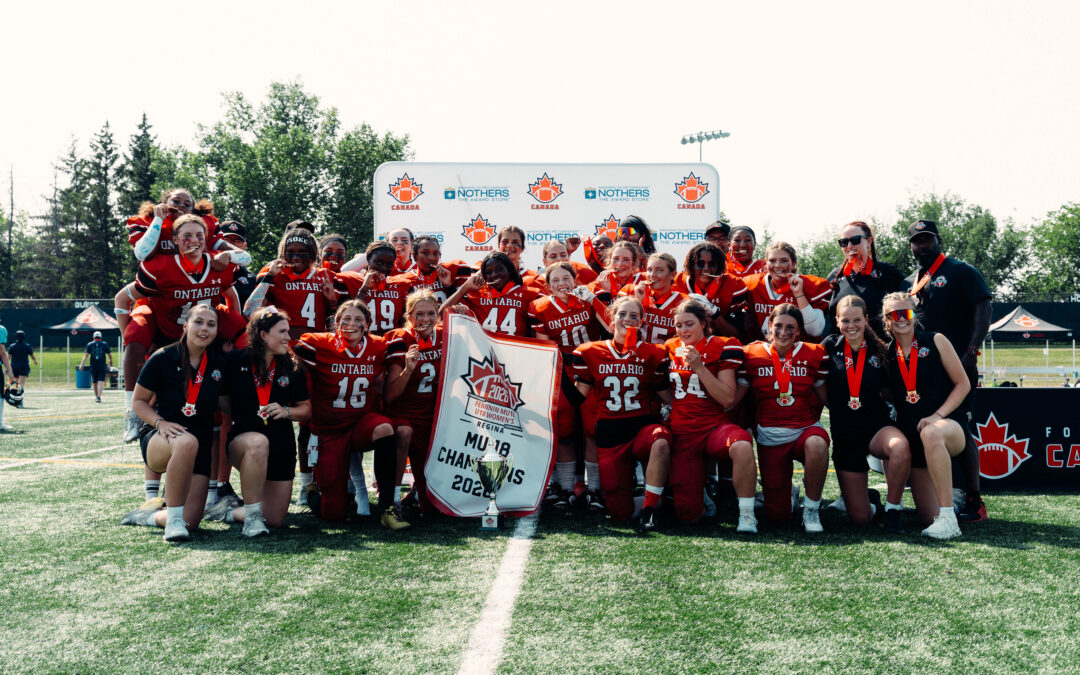 2026 Team Ontario U18 Women's Tackle team celebrating with medals, trophy and the national champions banner in Regina